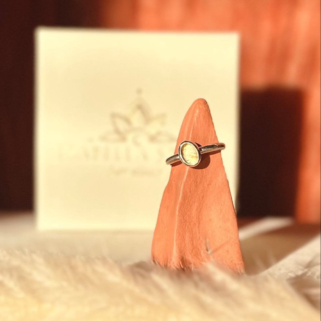 Ring on a pink feather with a blurred background